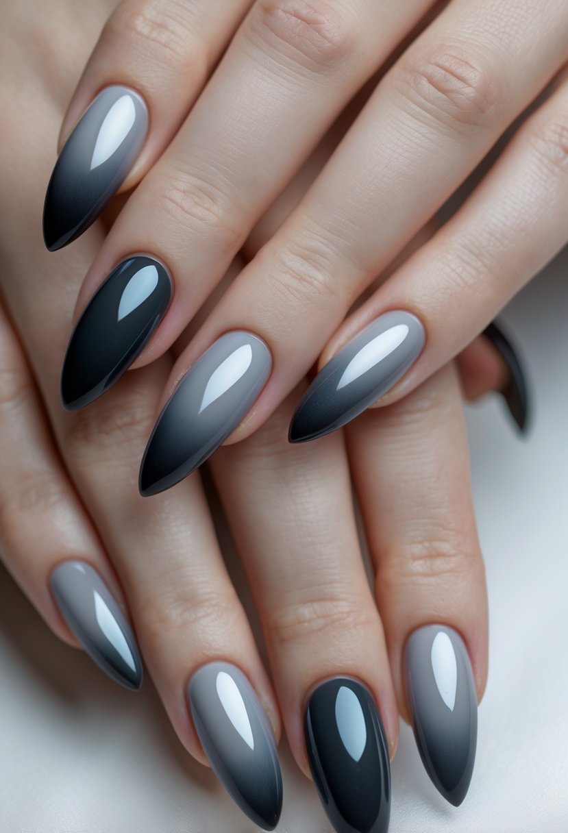 Close-up of two hands with long almond-shaped nails featuring a smokey grey gradient design.