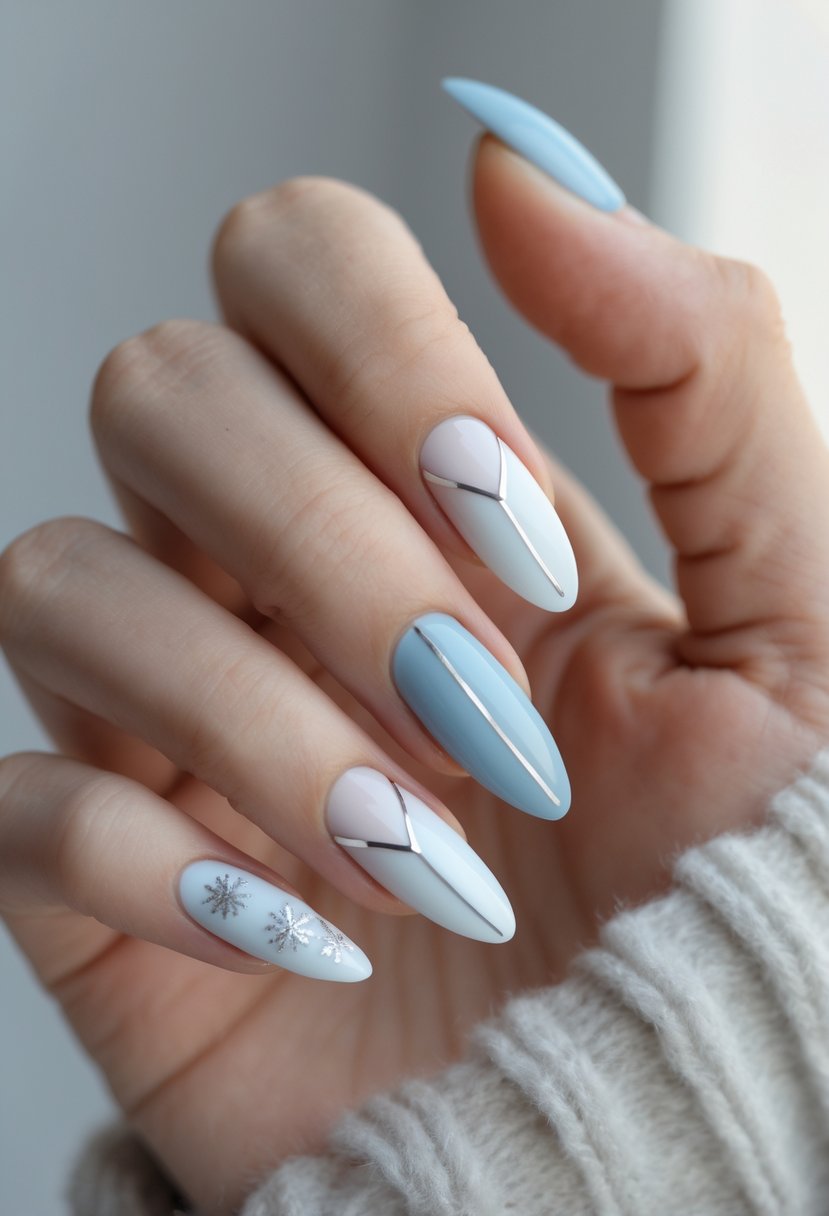 Close-up of hands with minimalist winter-themed nails in pale blue and white tones against a neutral background.