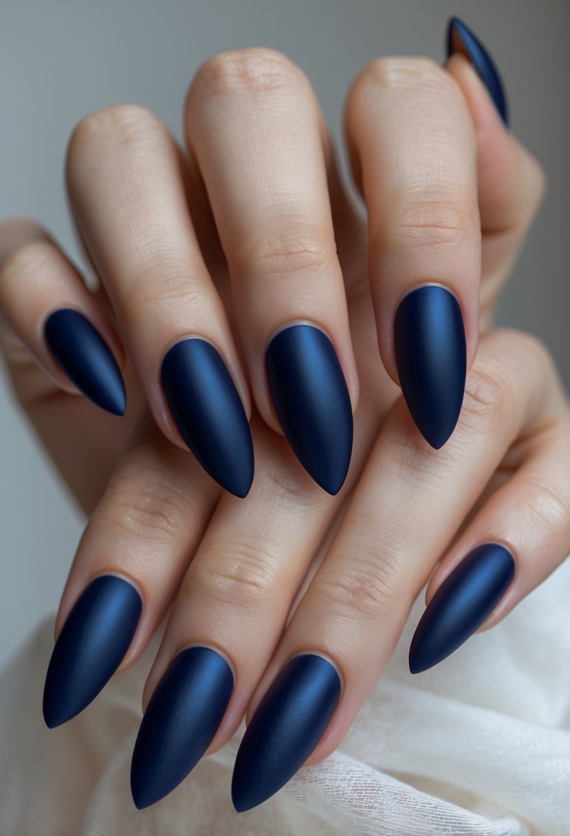 Close-up of hands with long blue nails featuring matte bases and glossy tips.